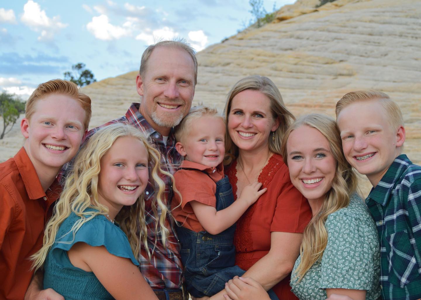 Family portrait in Southern Utah with pale desert rocks behind them
