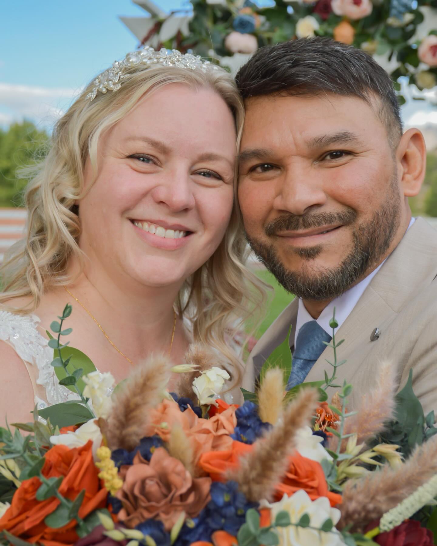 Couple smiling together with a bouquet